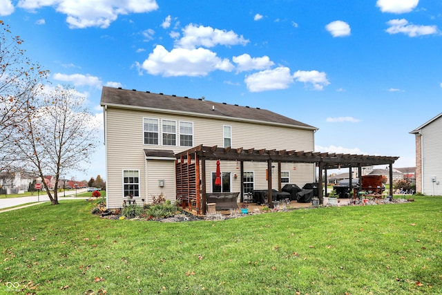 back of property featuring a yard, a pergola, and a patio area