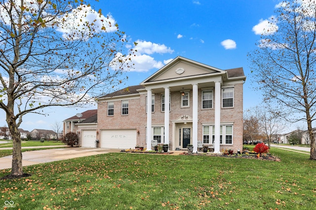 greek revival house featuring a front lawn and a garage