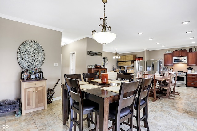 dining room with an inviting chandelier and crown molding