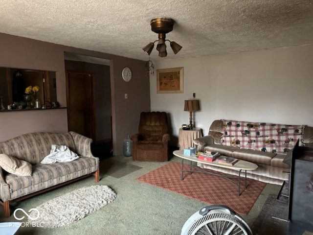 living room with carpet flooring, ceiling fan, and a textured ceiling