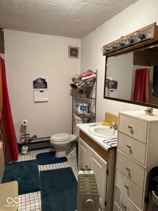 full bathroom featuring vanity, toilet, baseboard heating, and a textured ceiling