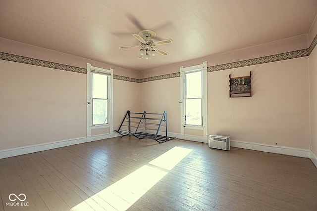 unfurnished room featuring ceiling fan, plenty of natural light, and wood-type flooring