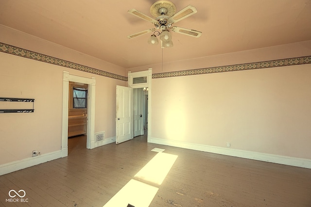 empty room with ceiling fan and dark wood-type flooring