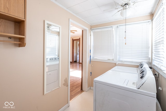 clothes washing area featuring light wood-type flooring, independent washer and dryer, and ornamental molding