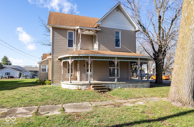 view of front of house featuring covered porch and a front yard