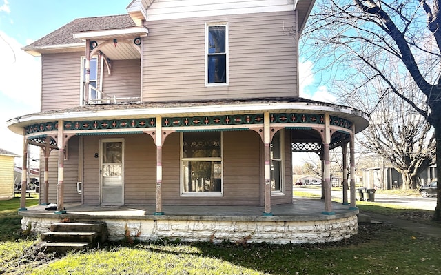 rear view of property featuring a porch