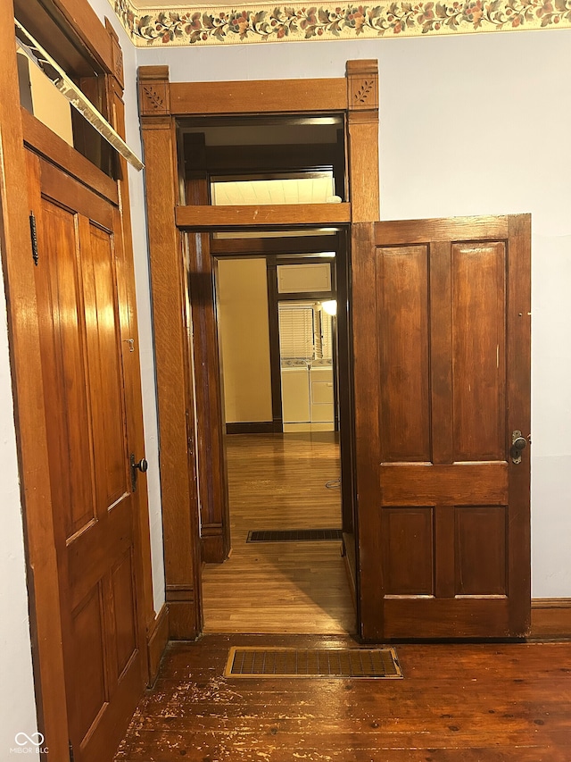 hall with dark hardwood / wood-style flooring