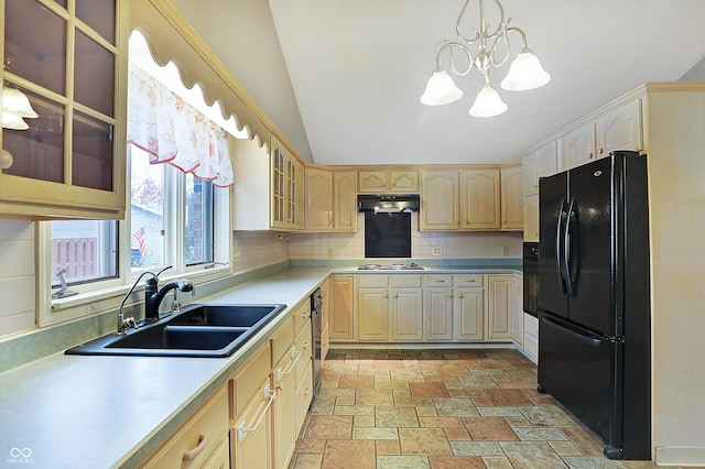 kitchen with light brown cabinetry, tasteful backsplash, sink, black appliances, and a notable chandelier