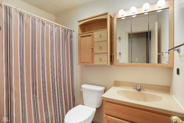 bathroom with vanity, a textured ceiling, and toilet