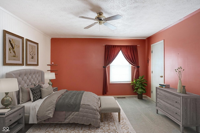 bedroom featuring ceiling fan, ornamental molding, a textured ceiling, and light carpet