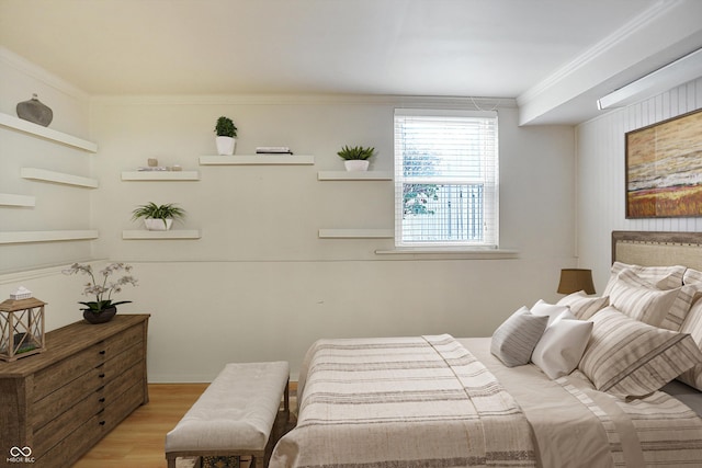 bedroom featuring light hardwood / wood-style floors and ornamental molding