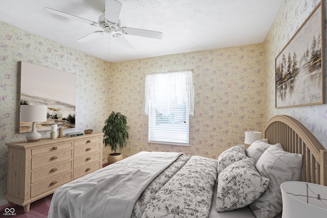 bedroom with ceiling fan and a textured ceiling