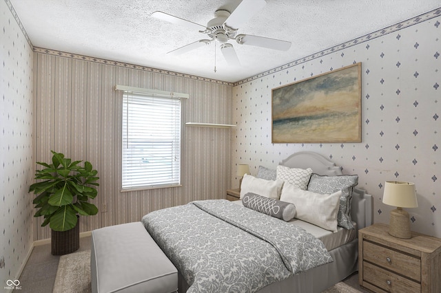 bedroom with carpet, ceiling fan, and a textured ceiling