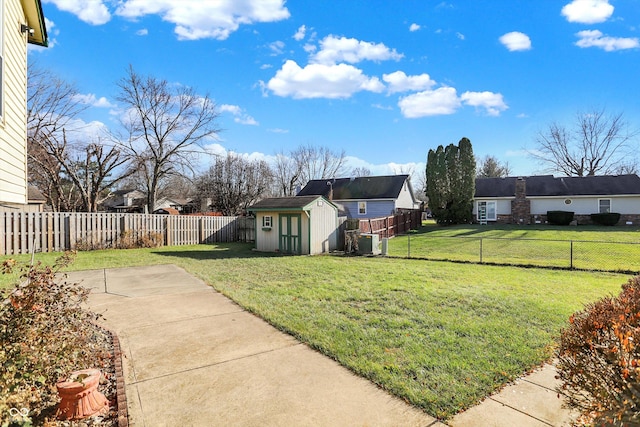 view of yard featuring a shed and a patio area