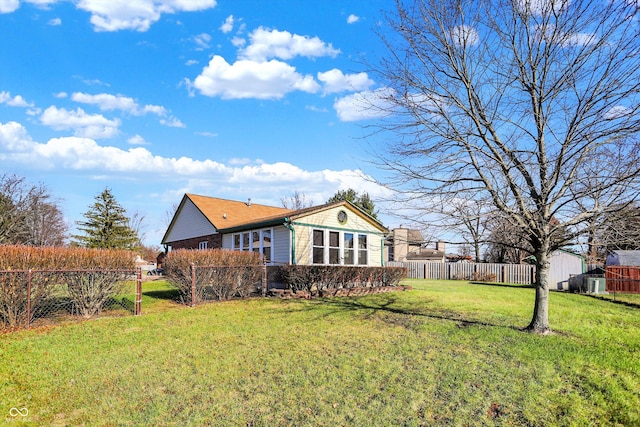 back of house with a lawn