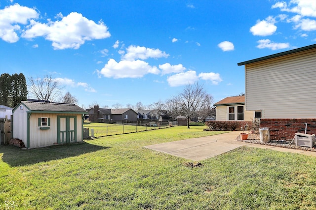 view of yard featuring a patio and a storage shed