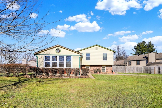 back of house featuring a yard