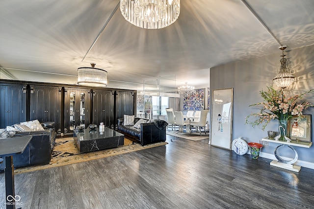 living room featuring a notable chandelier and dark hardwood / wood-style flooring