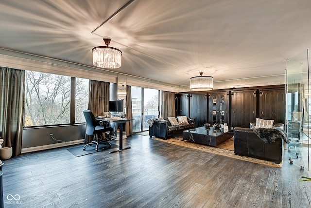 living room featuring a chandelier, hardwood / wood-style floors, and a healthy amount of sunlight