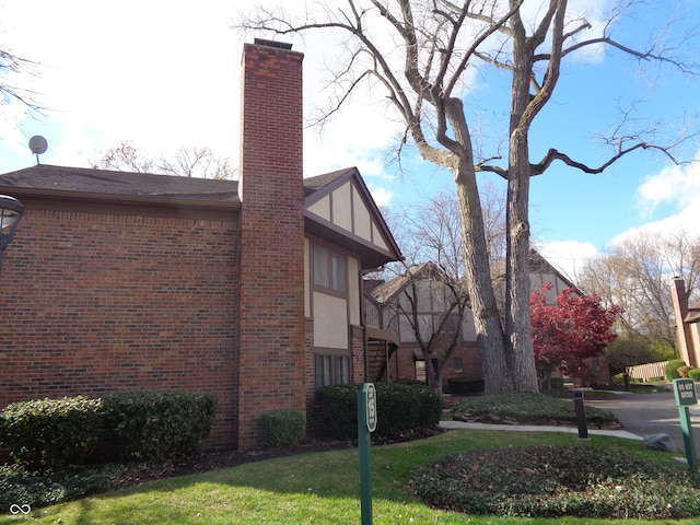 view of side of property with a lawn