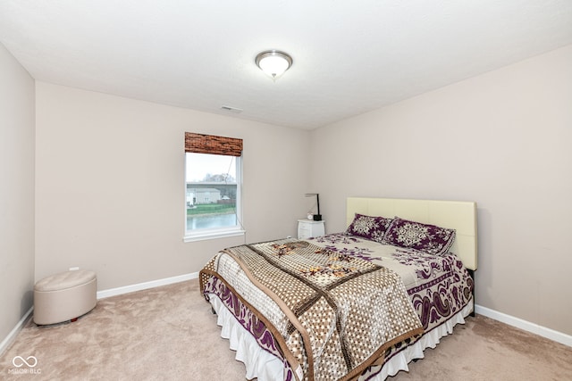 bedroom with light colored carpet