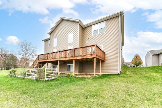 rear view of property featuring a lawn and a deck