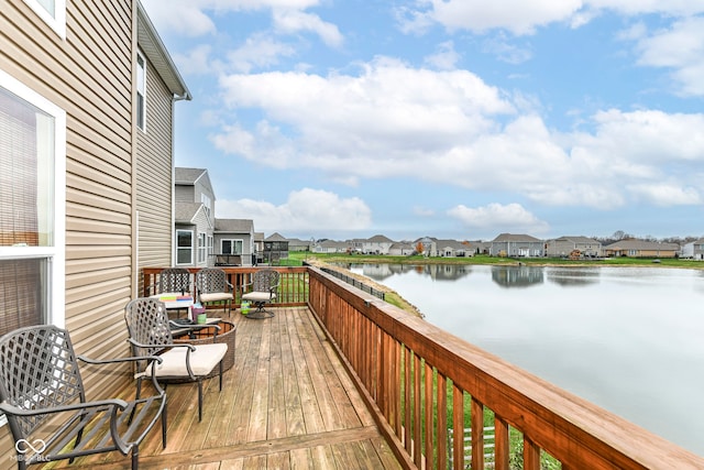 wooden terrace featuring a water view