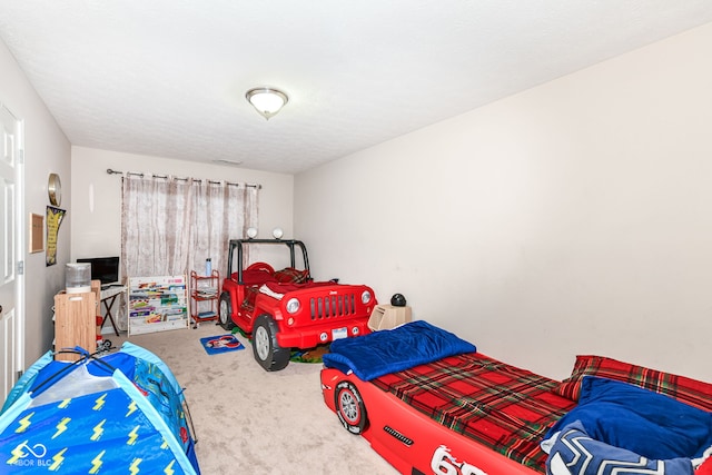 carpeted bedroom with a textured ceiling