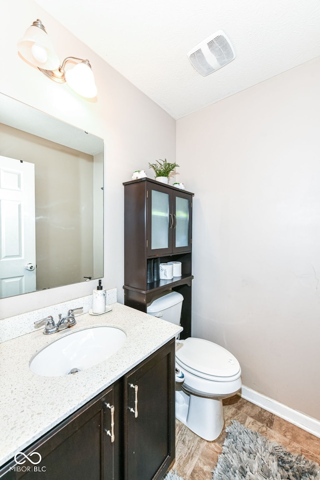 bathroom with vanity, hardwood / wood-style flooring, and toilet