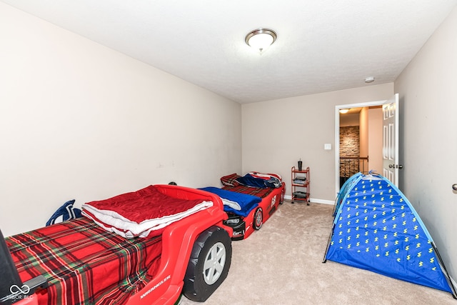 carpeted bedroom with a textured ceiling