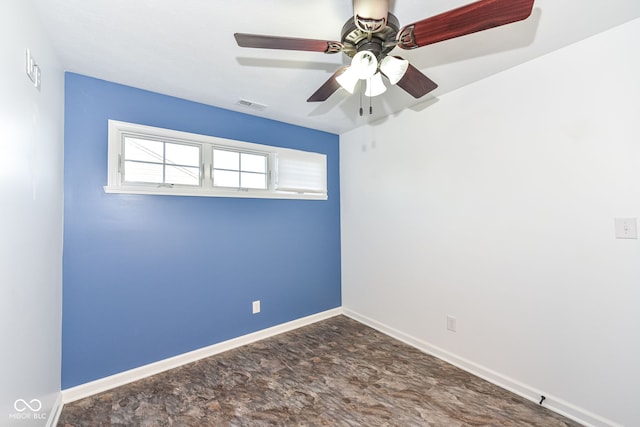 empty room featuring baseboards and visible vents