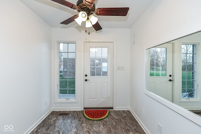 doorway with plenty of natural light and baseboards