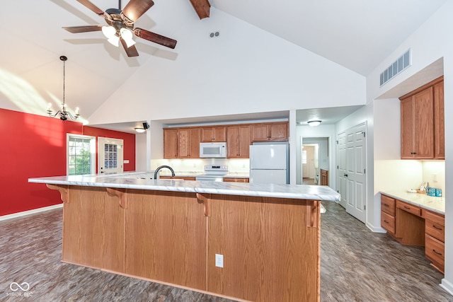 kitchen with brown cabinetry, white appliances, light countertops, and visible vents