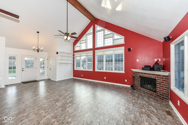 unfurnished living room featuring high vaulted ceiling, beamed ceiling, a fireplace, and baseboards