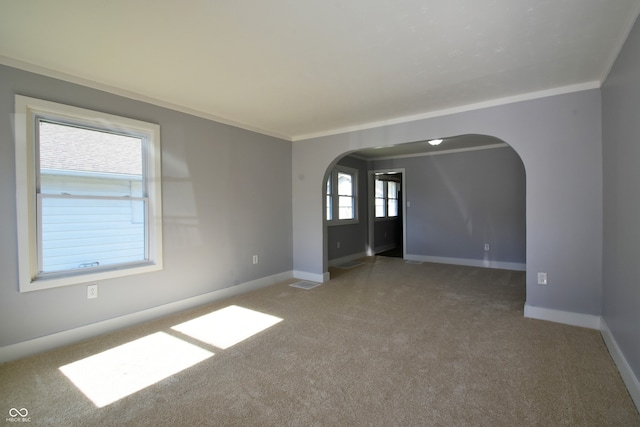 unfurnished room with carpet and crown molding