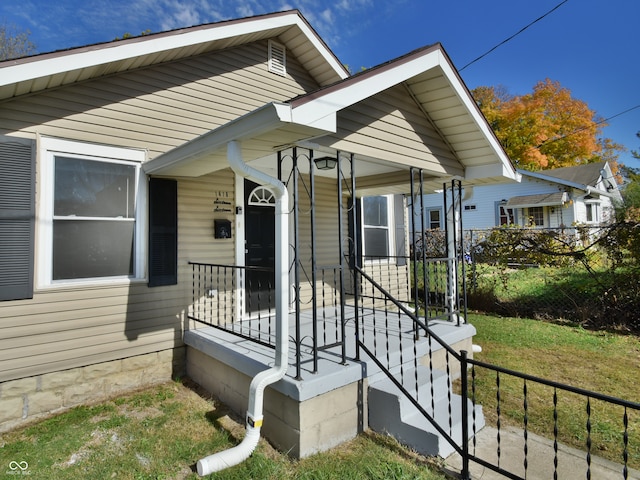 view of exterior entry with a porch