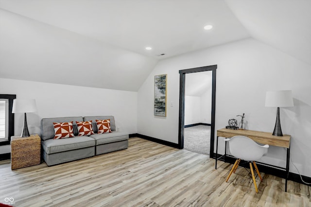 office area with light wood-type flooring and vaulted ceiling