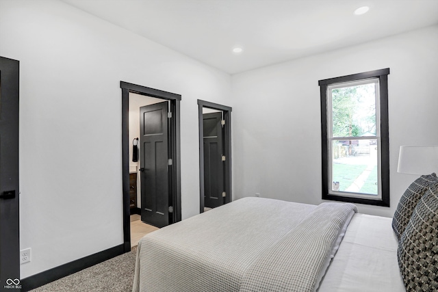 bedroom featuring light carpet