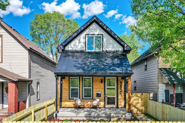 rear view of property with covered porch