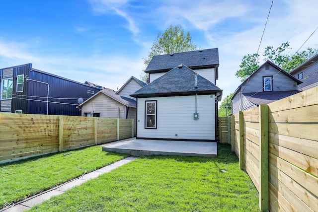 rear view of property featuring a yard and a patio