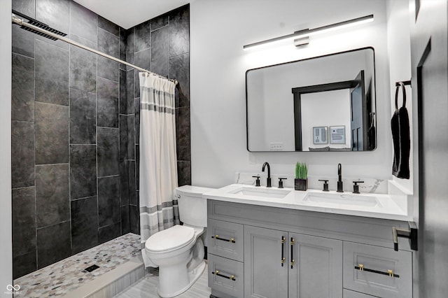 bathroom featuring toilet, vanity, and a shower with shower curtain