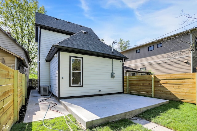 rear view of house with a patio area and central air condition unit