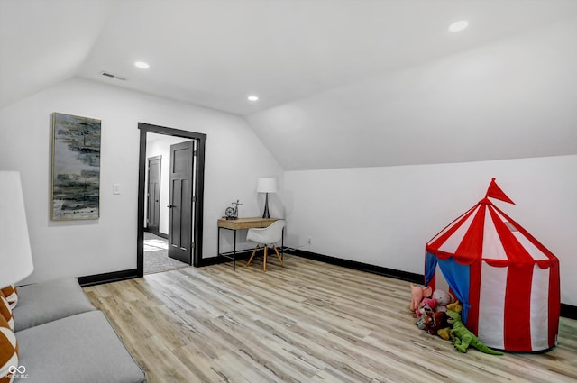 additional living space featuring light hardwood / wood-style flooring and vaulted ceiling