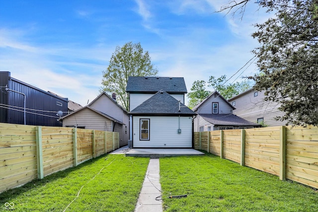 rear view of house featuring a yard and a patio