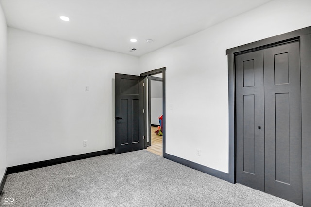 unfurnished bedroom featuring light carpet