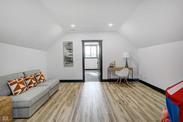 interior space featuring light hardwood / wood-style flooring and vaulted ceiling