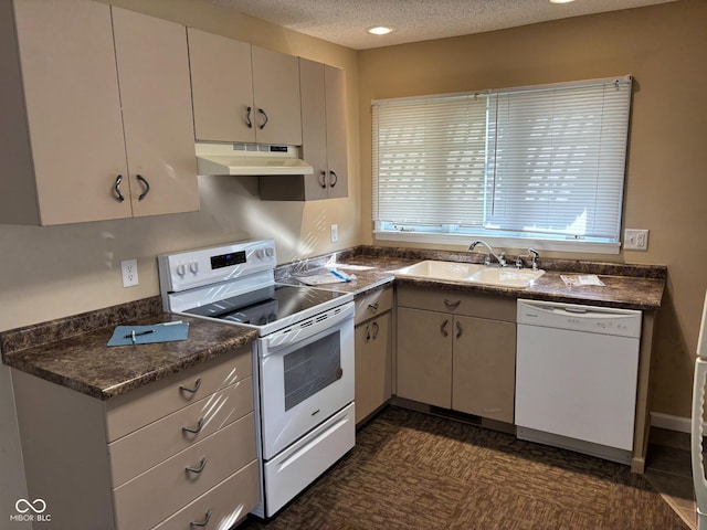 kitchen featuring a textured ceiling, white appliances, and sink