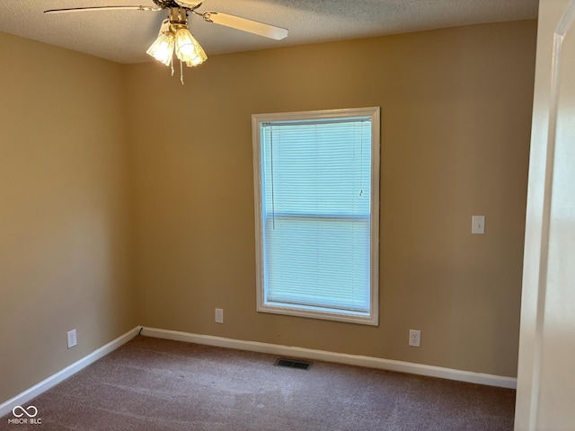 unfurnished room featuring ceiling fan, carpet, and a textured ceiling