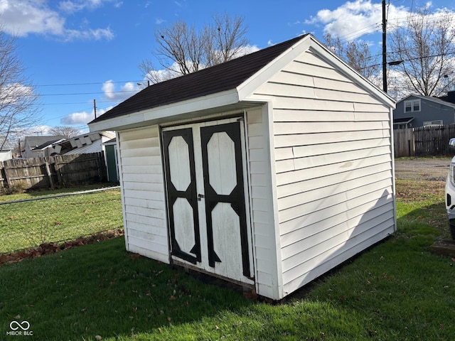 view of outbuilding with a yard