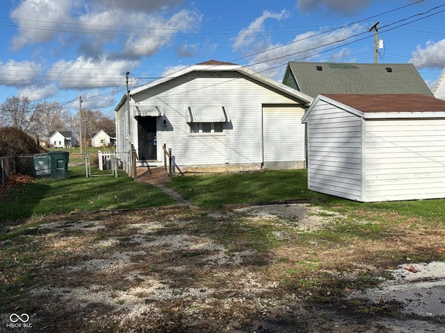 back of house with a lawn